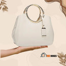 Bag- Eco-leather (PU); color white; arm extended and hand open over the hand the bag; vibe houses