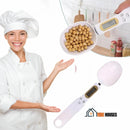 Woman dressed as chef, smiling, points with her hands to digital spoon; Vibe houses