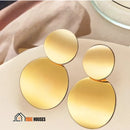 Earrings; Pair of golden double disc earrings, Semijoias, On a light orange fleece; Vibe Houses