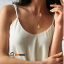 Pendant Necklace. Initial AZ - Semi jewel. 18k gold plated. A woman dressed in a strappy dress. Highlights the detail of the necklace. vibe houses