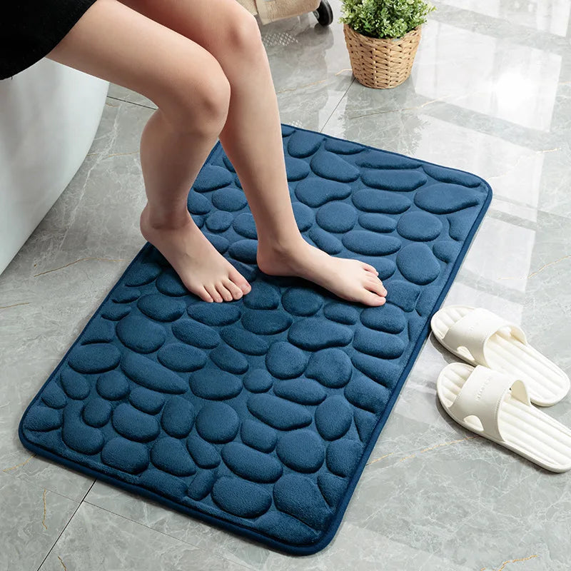 Bare feet step on the blue absorbent mat when leaving the bath, beautiful and safe. Vibe Houses