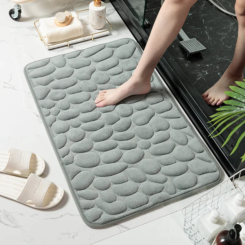 Bare feet step on the gray absorbent mat when leaving the bath, beautiful and safe. Vibe Houses