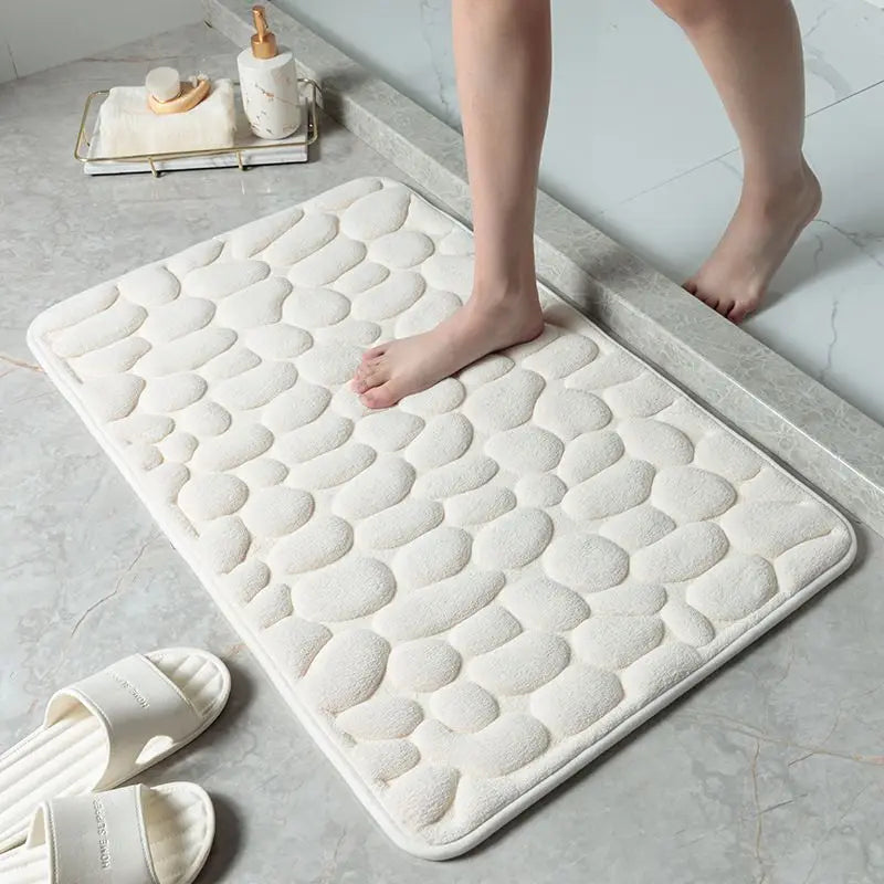 Bare feet step on the white absorbent mat when leaving the bath, beautiful and safe. Vibe Houses