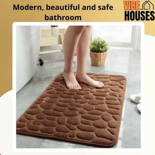 Bare feet step on the absorbent brown mat. Modern, beautiful and safe bathroom. Vibe Houses