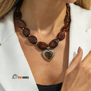 Necklace | heart pendant, woman wears around her neck, color brown, vibe houses