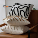 Vintage Cushion Cover; Three cushion covers together and on top of the chair The cushions have the colors black, beige and coffee; vibe houses