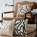 Vintage Cushion Cover; Three cushion covers together, the first in cage color is on a chair and the other two in beige and black on the floor; vibe houses