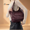 The Margaret bag, a woman wears it on her shoulder; vibe houses