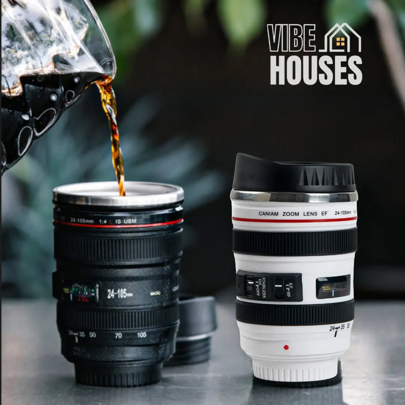 Stainless steel mug with camera lens! 📷 Two mugs, one white and the other black. The black mug is receiving liquid from a pitcher. CreatMug. Vibe Houses