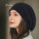 CozyMuse beanie; woman wears black beanie on her head; vibe houses