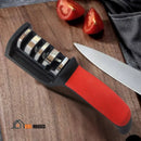 Scissor And knife Sharpener – On a table. With aerial image. It has a wooden board with a cut tomato, a knife nearby and the knife sharpener and scissors. SharpMaster by Vibe Houses