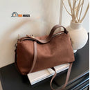 Solea bag - Brown, placed on a book next to a vase arrangement vibe houses