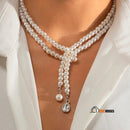 Necklace | Long pearl necklace with crystal pendants. Woman wears necklace around her neck, vibe houses