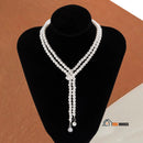 Necklace | Long pearl necklace with crystal pendants. Jewelry seen on display, vibe houses